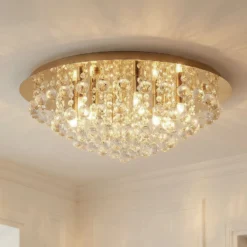 Lindby Deckenleuchte Gillion, 8-flg., gold, Kristall, Ø 55cm
