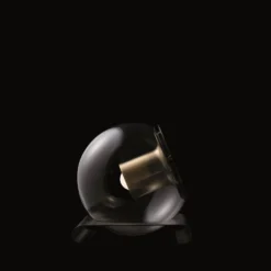 Oluce Tischleuchte The Globe, goldfarben/bronze, Glas
