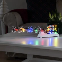 Tischdeko Schneemann mit Hundeschlitten bunte LEDs